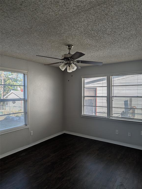 4655 Norris Street Fort Worth, TX 76105 - Photo 3 of 13 a view of an empty room with wooden floor and a window