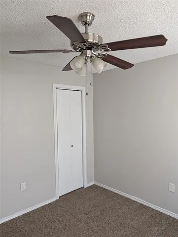 an empty room with a fan