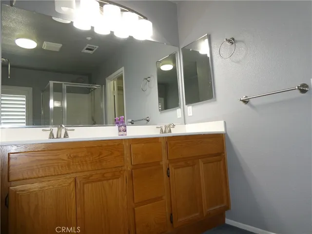 a bathroom with a double vanity sink and a mirror