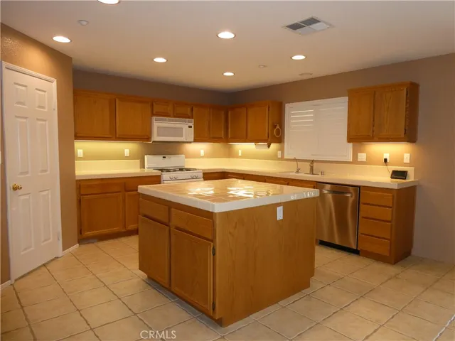 a kitchen with a sink window and cabinets