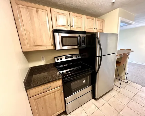 a kitchen with granite countertop a sink and a window