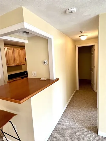 an empty room with a mirror and a ceiling fan