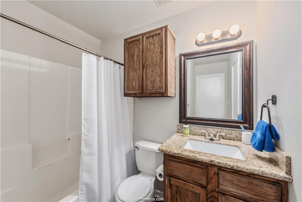 1209 Oney Hervey Drive College Station, TX 77840 - Photo 16 of 22 a bathroom with a granite countertop sink and a mirror