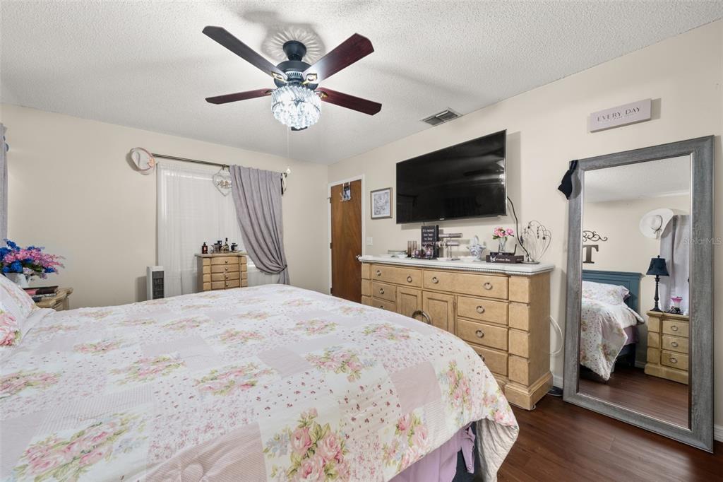 443 Foxdale Road Lake Placid, FL 33852 - Photo 16 of 31 a bedroom with a bed and a flat screen tv