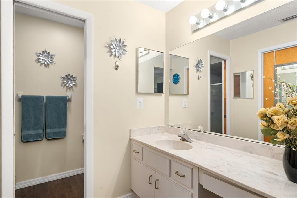 443 Foxdale Road Lake Placid, FL 33852 - Photo 17 of 31 a bathroom with a granite countertop sink a mirror and a shower