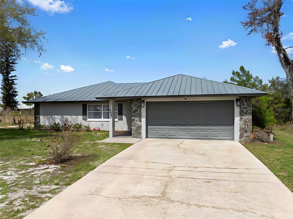443 Foxdale Road Lake Placid, FL 33852 - Photo 2 of 31 a front view of a house with a yard and garage