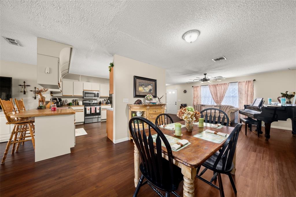 443 Foxdale Road Lake Placid, FL 33852 - Photo 5 of 31 a view of a dining room with furniture and wooden floor