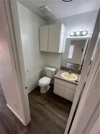 a bathroom with a toilet sink and mirror