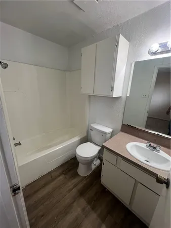 a bathroom with a sink a toilet and a bathtub