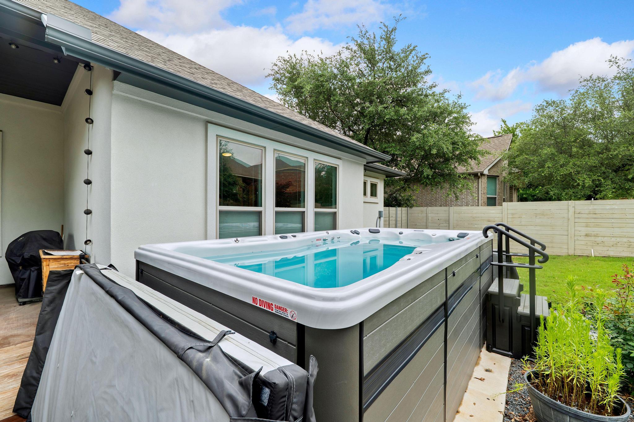 1009 Legacy Crossing Georgetown, TX 78628 - Photo 32 of 40 A private outdoor spa awaits relaxation, nestled beside a fenced yard.
