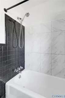 a bathroom with a bathtub and shower