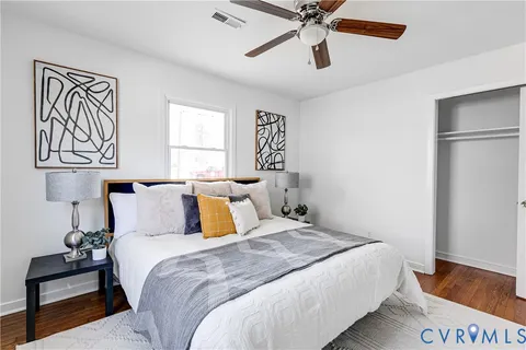 a bedroom with a bed and wooden floor