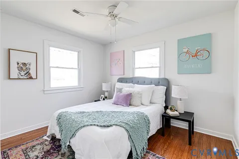 a bedroom with a bed and a painting on the wall