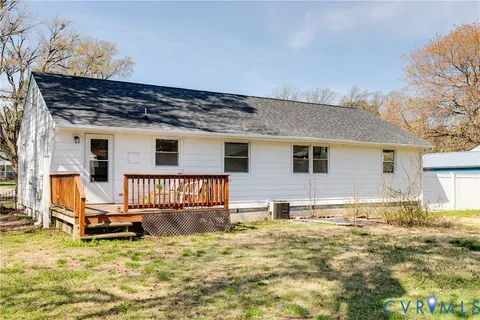a view of a house with a yard covered in snow