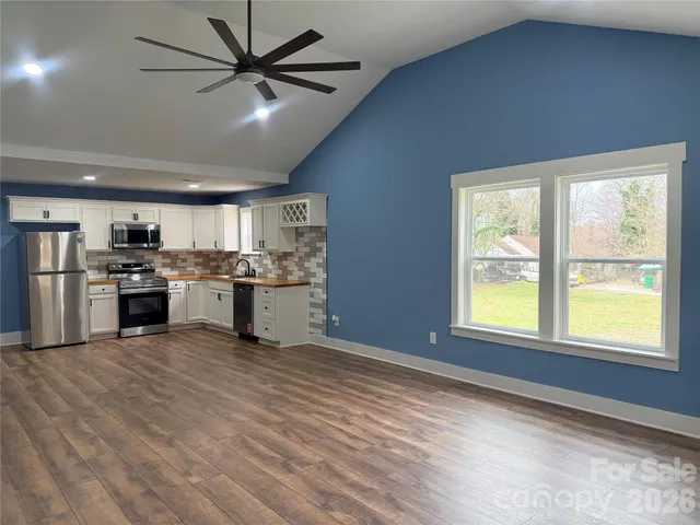 a view of a kitchen with a stove cabinets and a large window