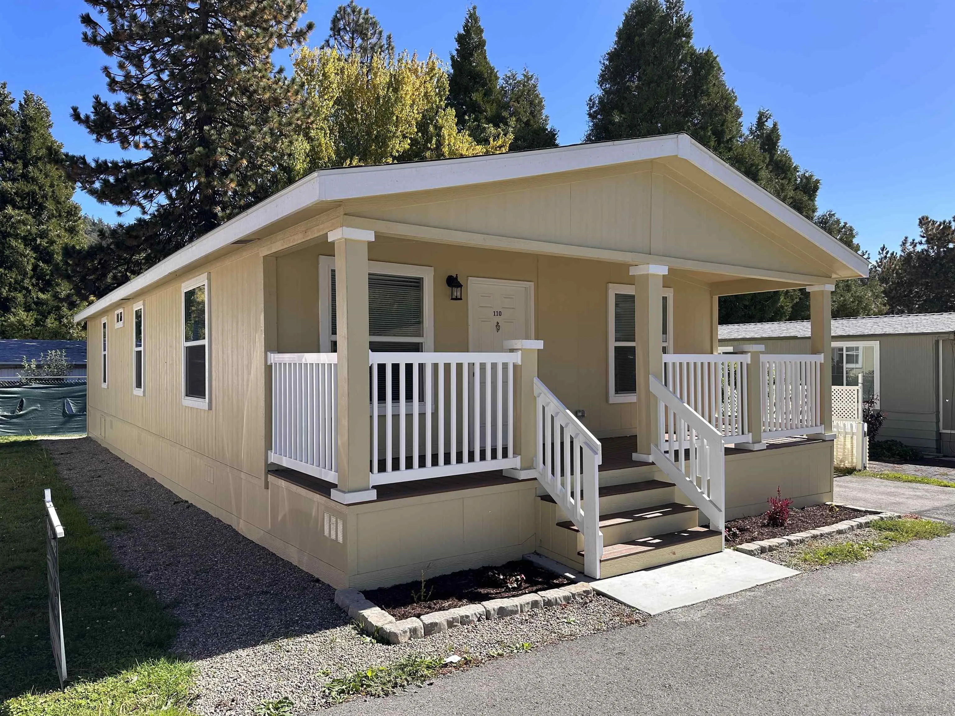 22899 Byron Road, Unit 110 Crestline, CA 92325 - Photo 3 of 5 a view of a house with a yard and deck