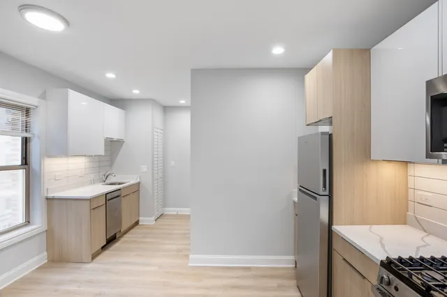 a kitchen with stainless steel appliances granite countertop a refrigerator and a sink