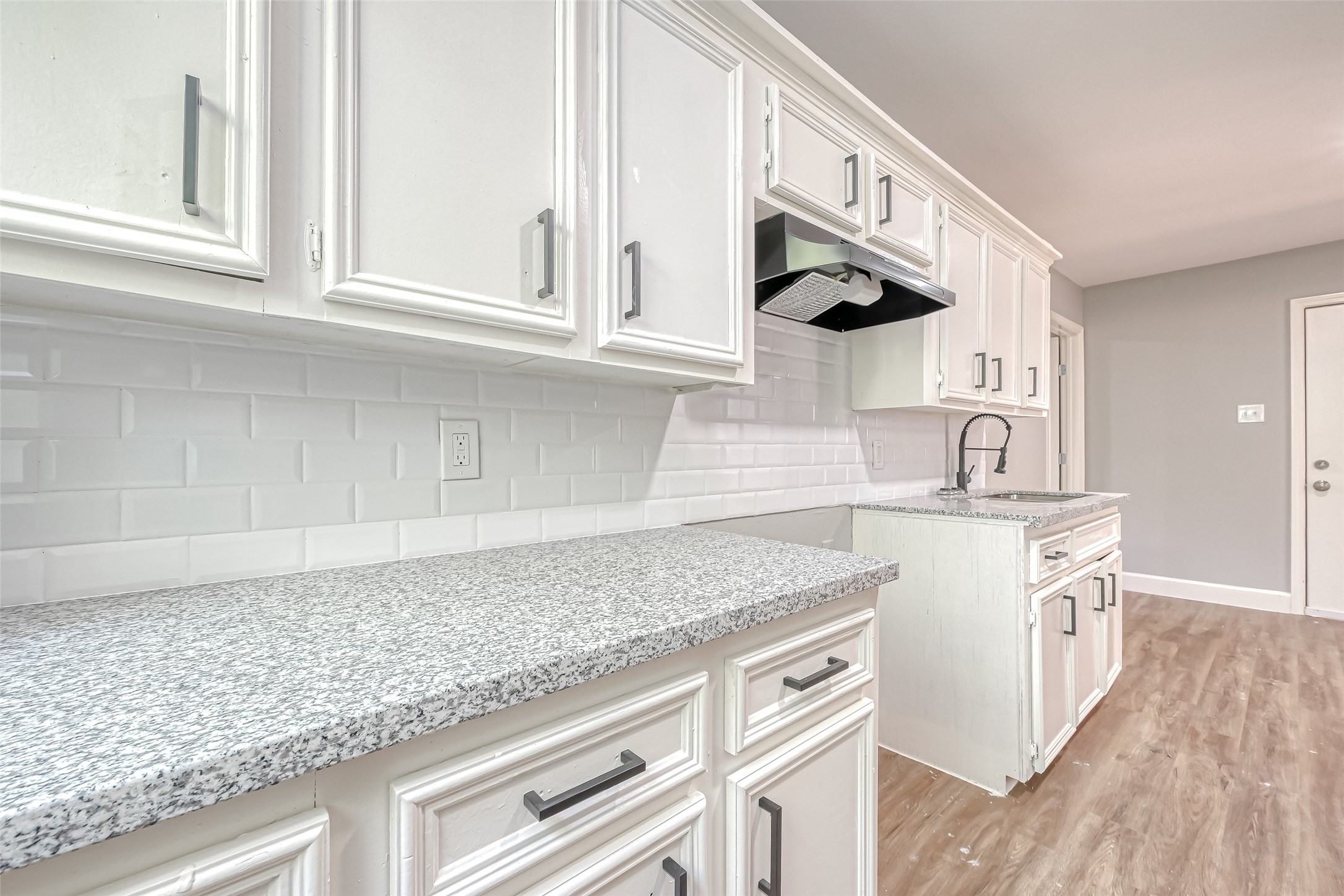 6715 Victoria Street Houston, TX 77020 - Photo 36 of 46 a kitchen with stainless steel appliances granite countertop a sink and a white cabinets