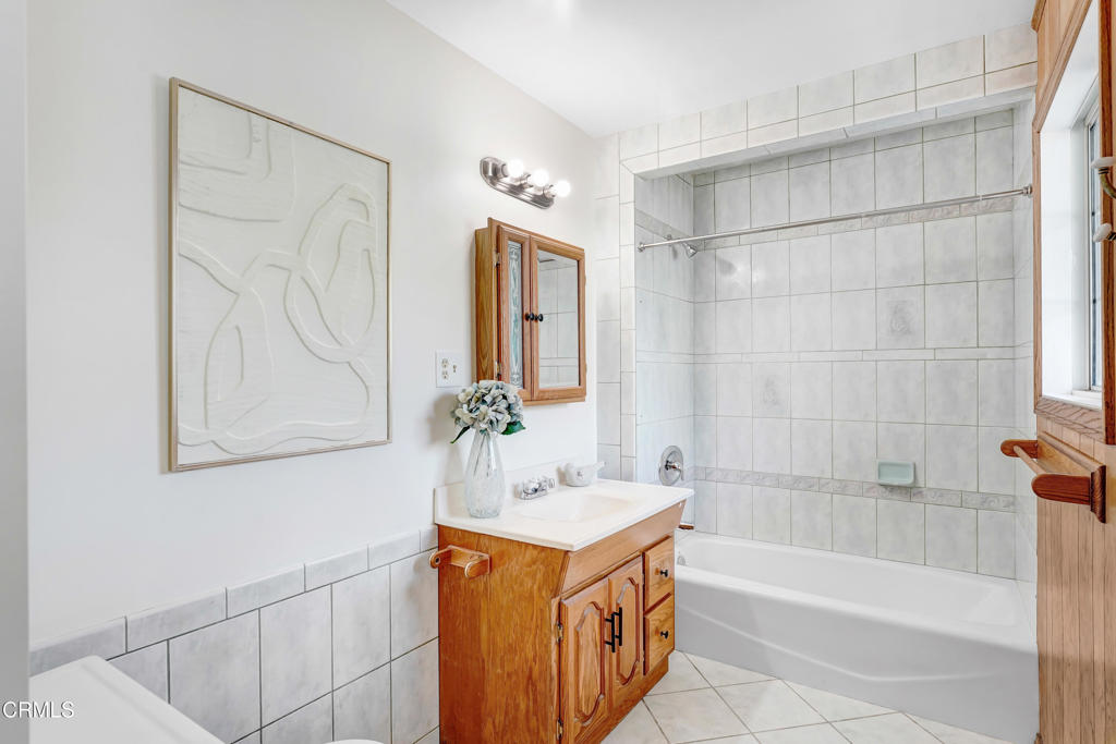907 North Stoneman Avenue Alhambra, CA 91801 - Photo 11 of 19 a bathroom with a tub sink and mirror