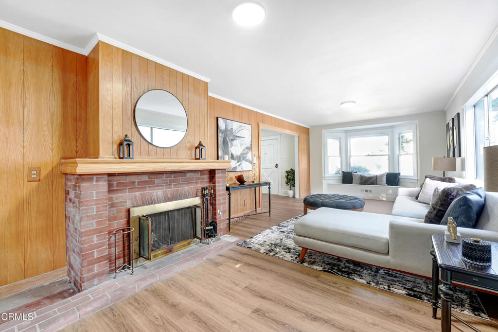 907 North Stoneman Avenue Alhambra, CA 91801 - Photo 6 of 19 a living room with furniture a fireplace and a large window