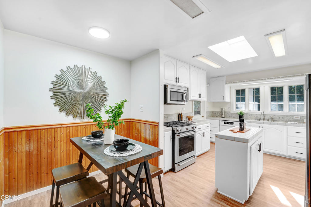 907 North Stoneman Avenue Alhambra, CA 91801 - Photo 7 of 19 a kitchen with a table chairs stove and cabinets