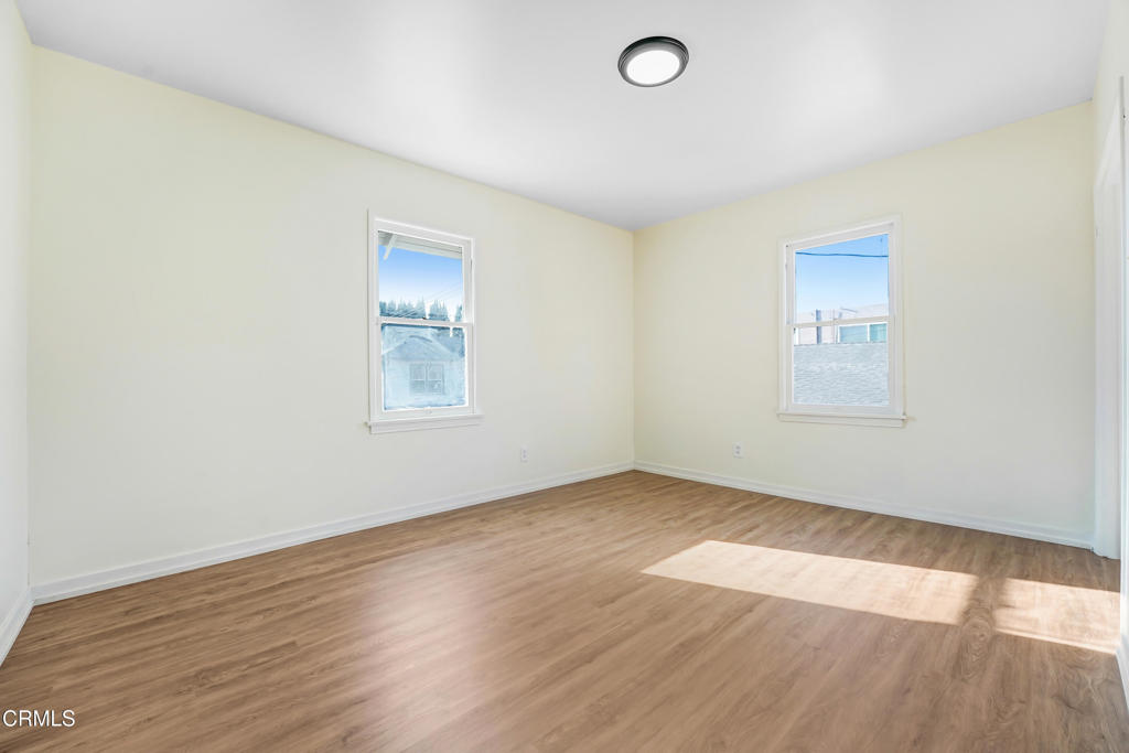 907 North Stoneman Avenue Alhambra, CA 91801 - Photo 10 of 19 an empty room with wooden floor and windows