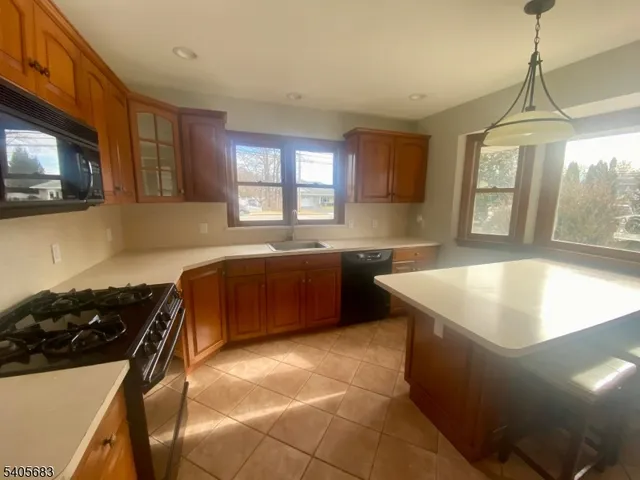 a kitchen with a sink a stove and a microwave