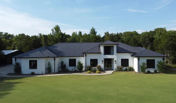 a front view of a house with swimming pool having outdoor seating