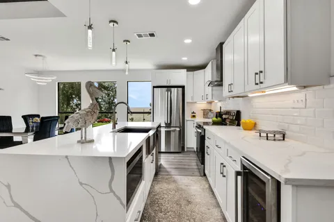 a kitchen with counter top space a sink stainless steel appliances and cabinets