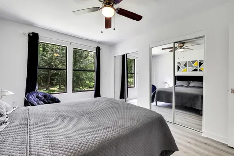 a bedroom with a bed and a large window