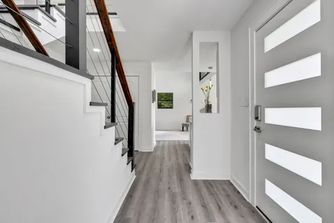 a view of a hallway view with wooden floor and staircase