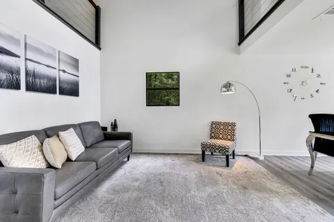 a living room with furniture and a chair