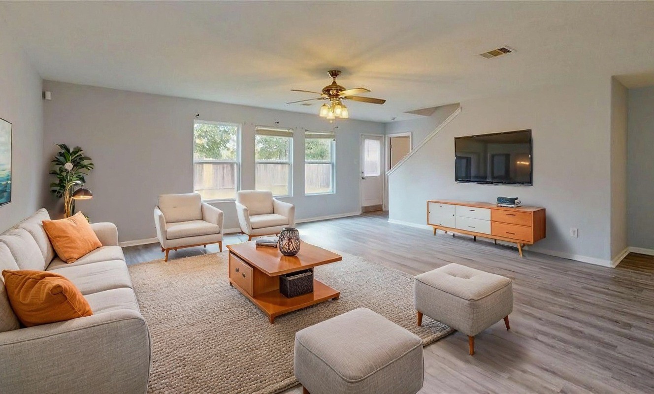 9877 Lace Flower Way Conroe, TX 77385 - Photo 3 of 43 a living room with furniture and a flat screen tv