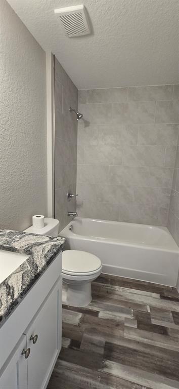 22 Pine Course Loop Ocala, FL 34472 - Photo 14 of 17 a bathroom with a granite countertop bathtub sink vanity mirror and toilet