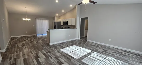 a view of kitchen and utility room with wooden floor