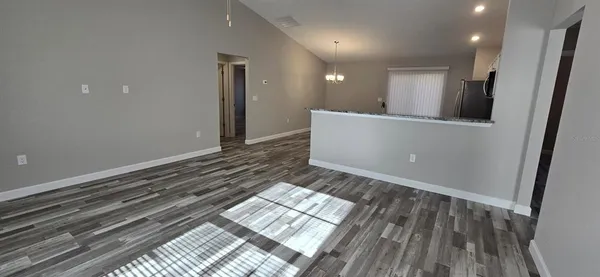 a view of a room with wooden floor