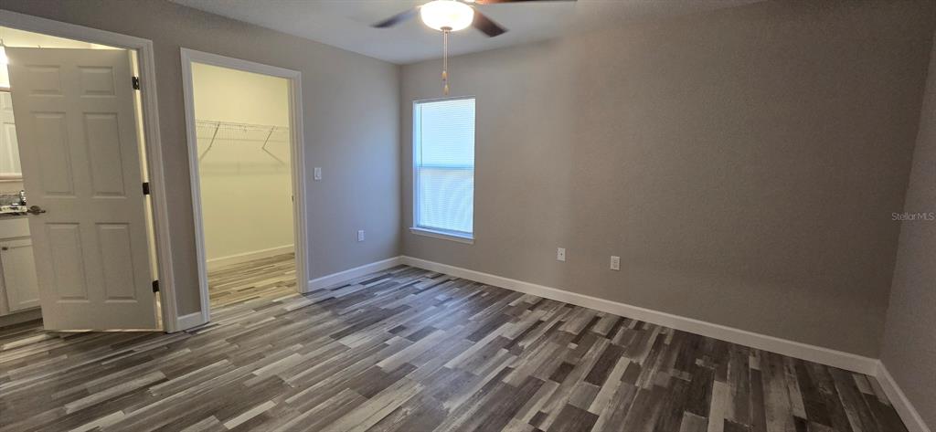 22 Pine Course Loop Ocala, FL 34472 - Photo 8 of 17 a view of an empty room with wooden floor and a window