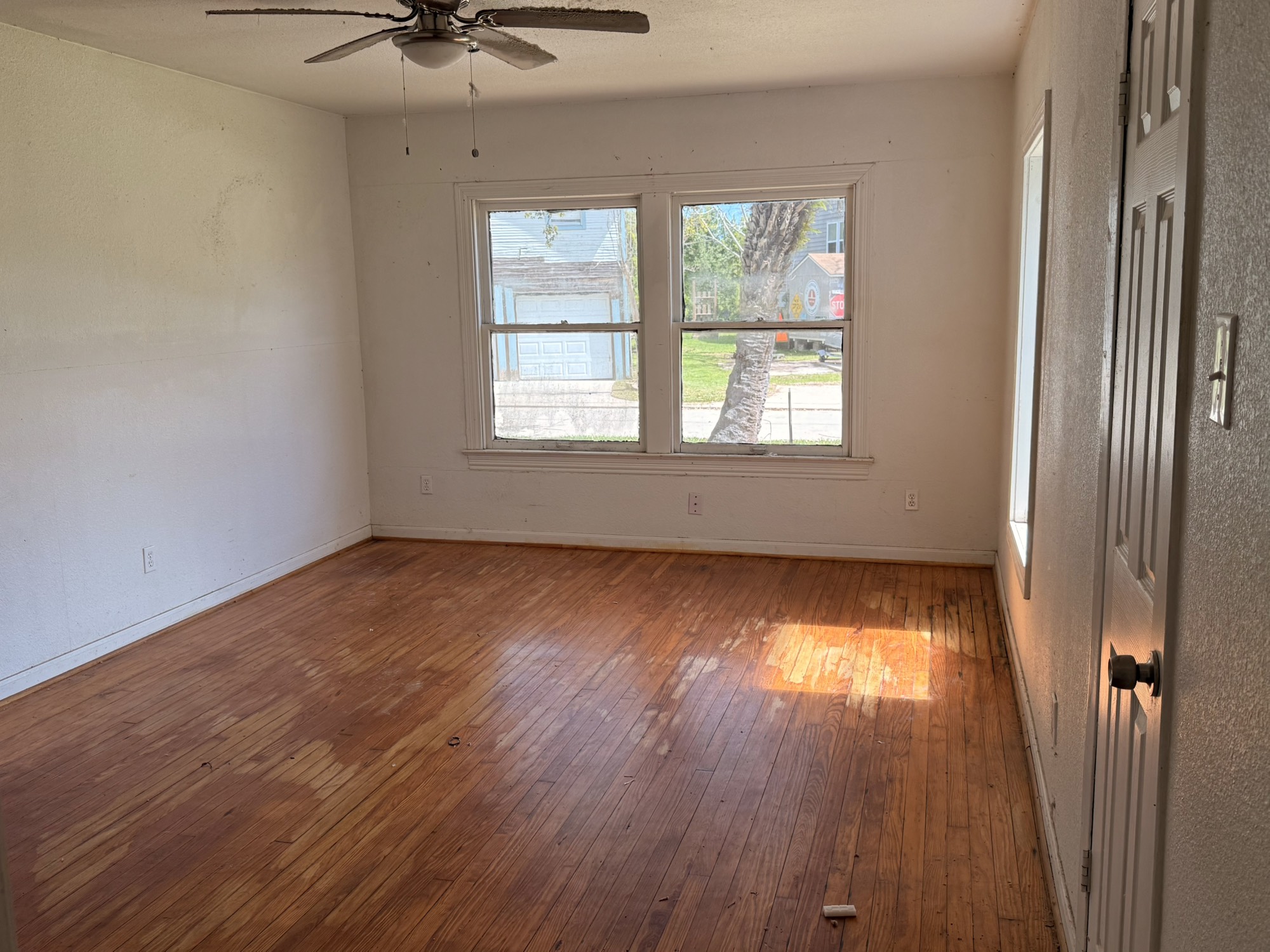 3122 Hamilton Street La Porte, TX 77571 - Photo 13 of 20 an empty room with wooden floor and windows