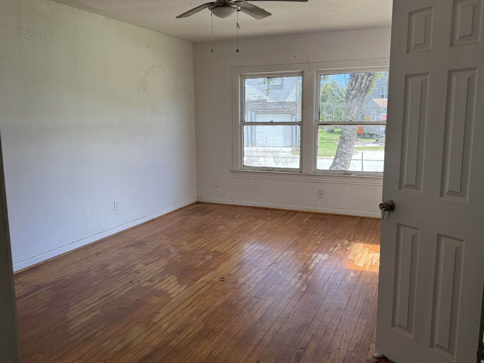 3122 Hamilton Street La Porte, TX 77571 - Photo 10 of 20 an empty room with wooden floor and windows
