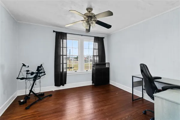 a view of a workspace with furniture and a window