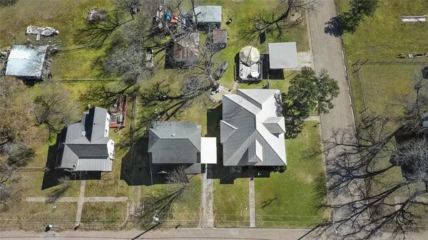 an aerial view of a house with a yard