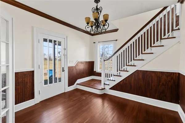a view of entryway and hall with wooden floor