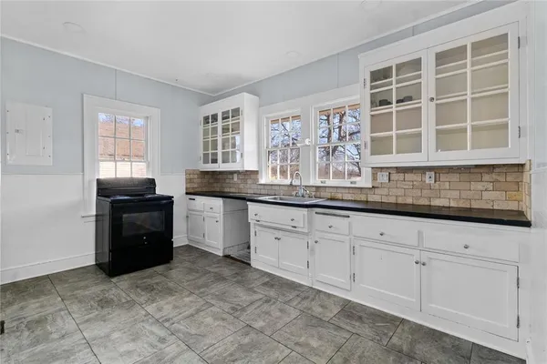 a kitchen with granite countertop a sink and cabinets