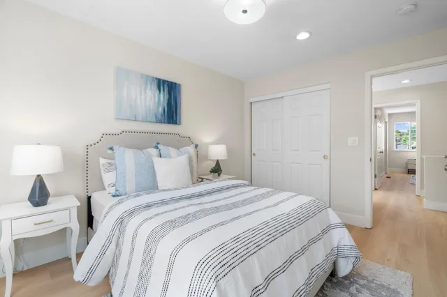 a bedroom with a bed and a lamp