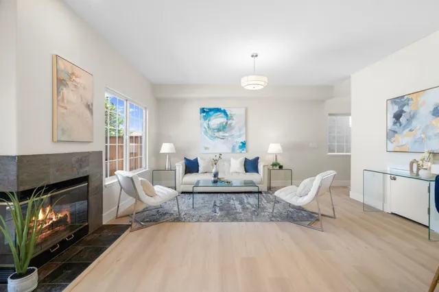 a living room with furniture a fireplace and a table