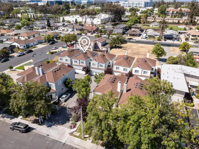 an aerial view of residential houses with green space