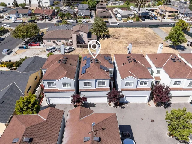an aerial view of a residential houses with outdoor space