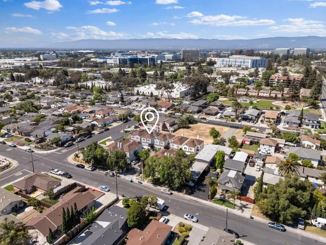 an aerial view of residential houses with city view
