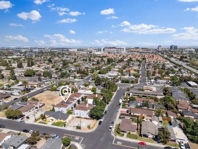 an aerial view of residential houses with city view