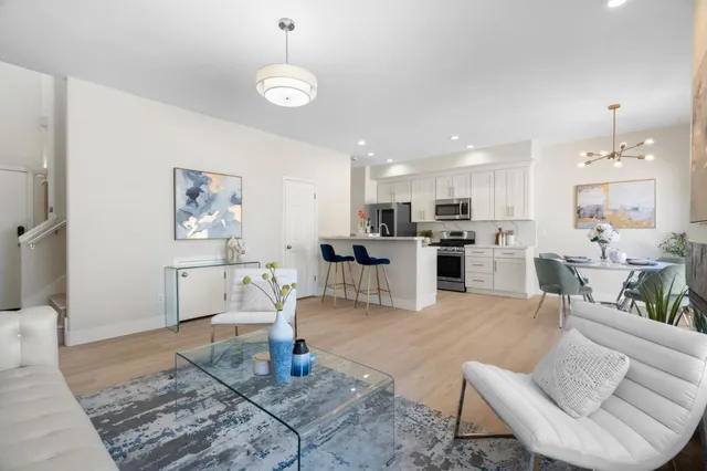a living room with furniture and kitchen view